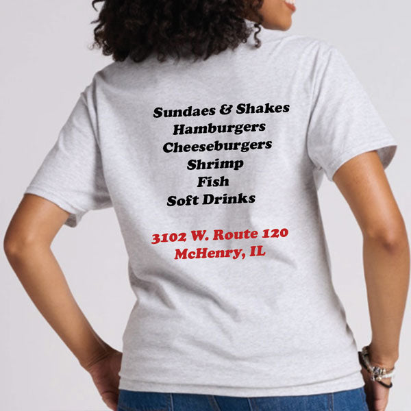Person wearing a white t-shirt with text on the back on a plain background