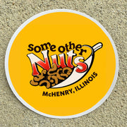 Round sticker with 'Some Other Nuts' logo and text on a textured surface