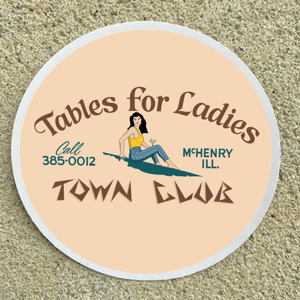 Round sign with text 'Tables for Ladies' and a phone number on a beige background
