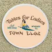 Round sign with text 'Tables for Ladies' and a phone number on a beige background